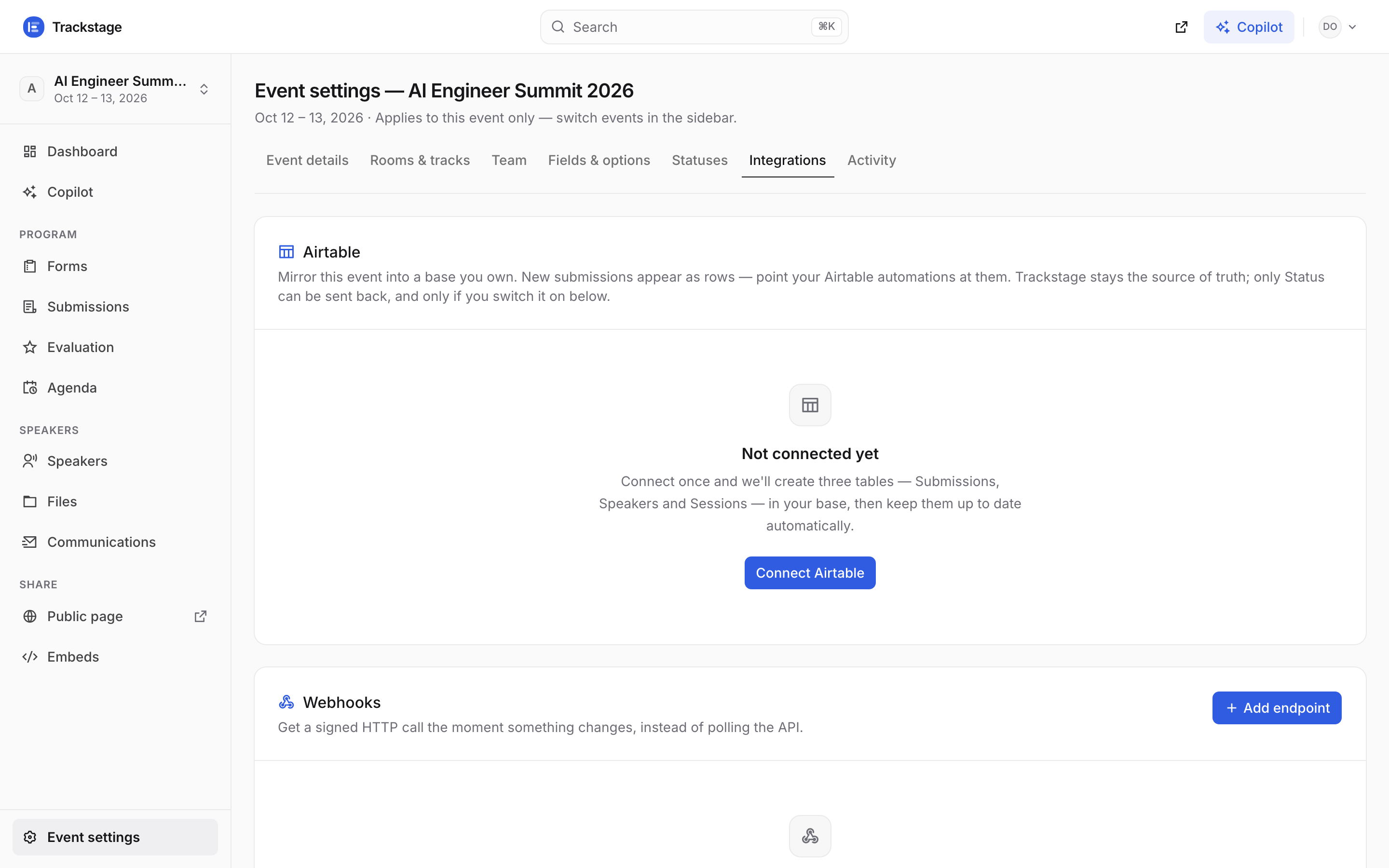 The event's Integrations settings tab with the Airtable card and the Webhooks card below it